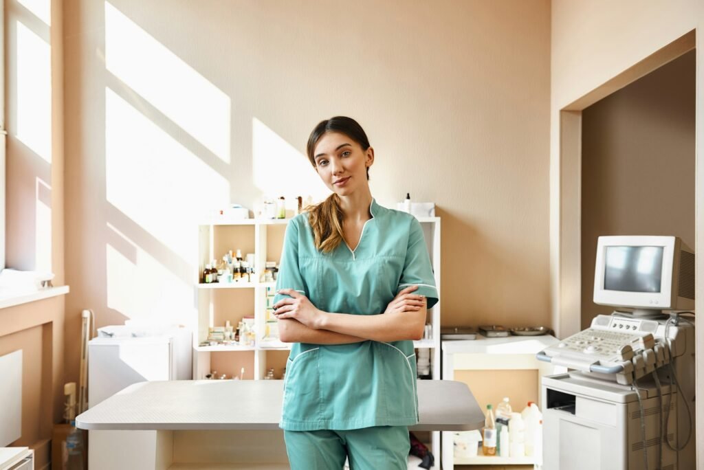 Professional doctor. Portrait of kind and young female veterinarian in work uniform standing with